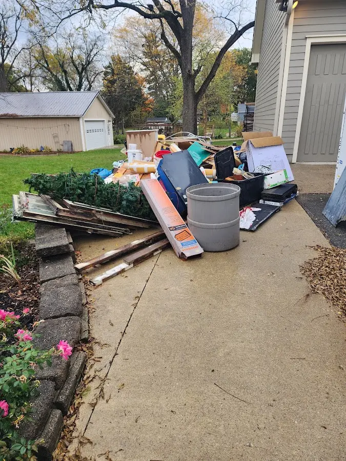 Dumpster being loaded with debris for 12 Yard Dumpster Rental in Lakeview